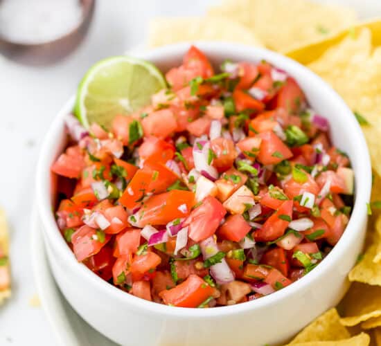 close up of easy homemade pico de gallo recipe in a bowl with chips around it
