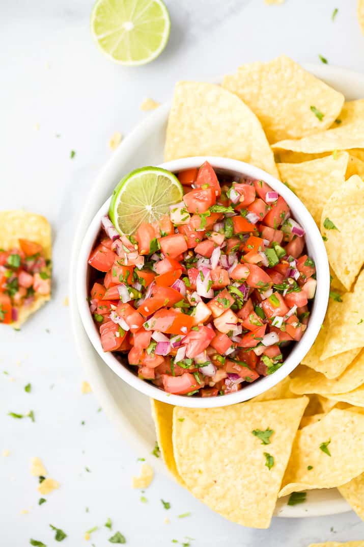 fresh pico de gallo in a bowl served with chips