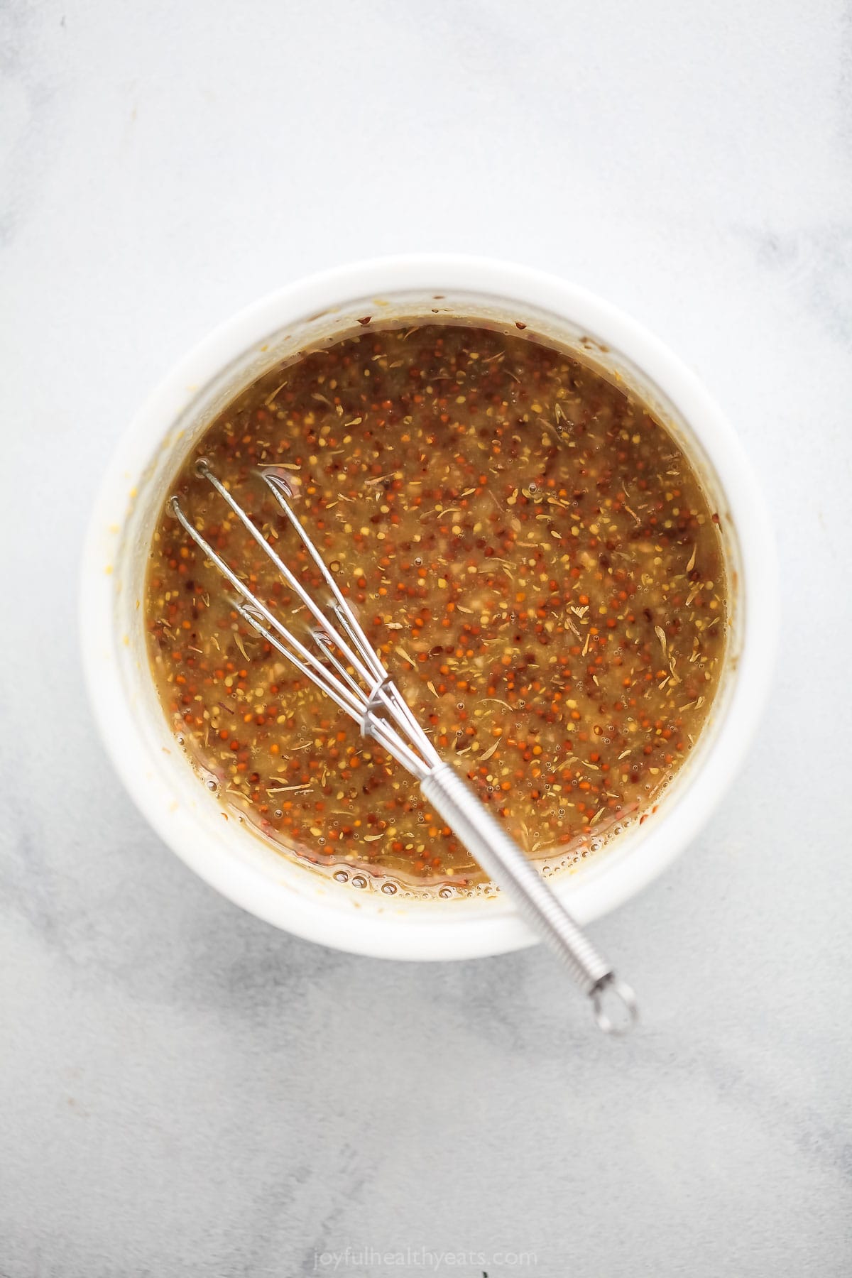 Whisked dressing in a bowl. 