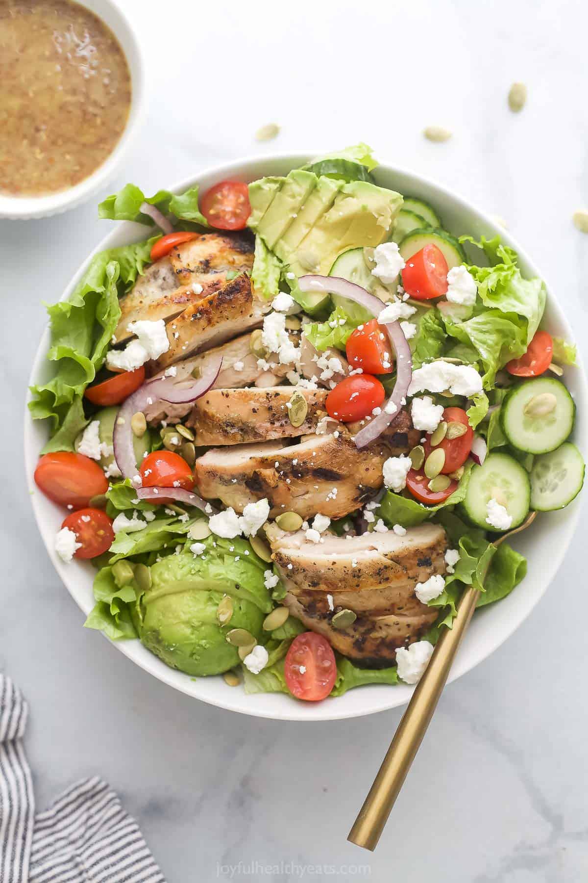 Chicken and avocado salad with cherry tomatoes and honey-mustard dressing. 