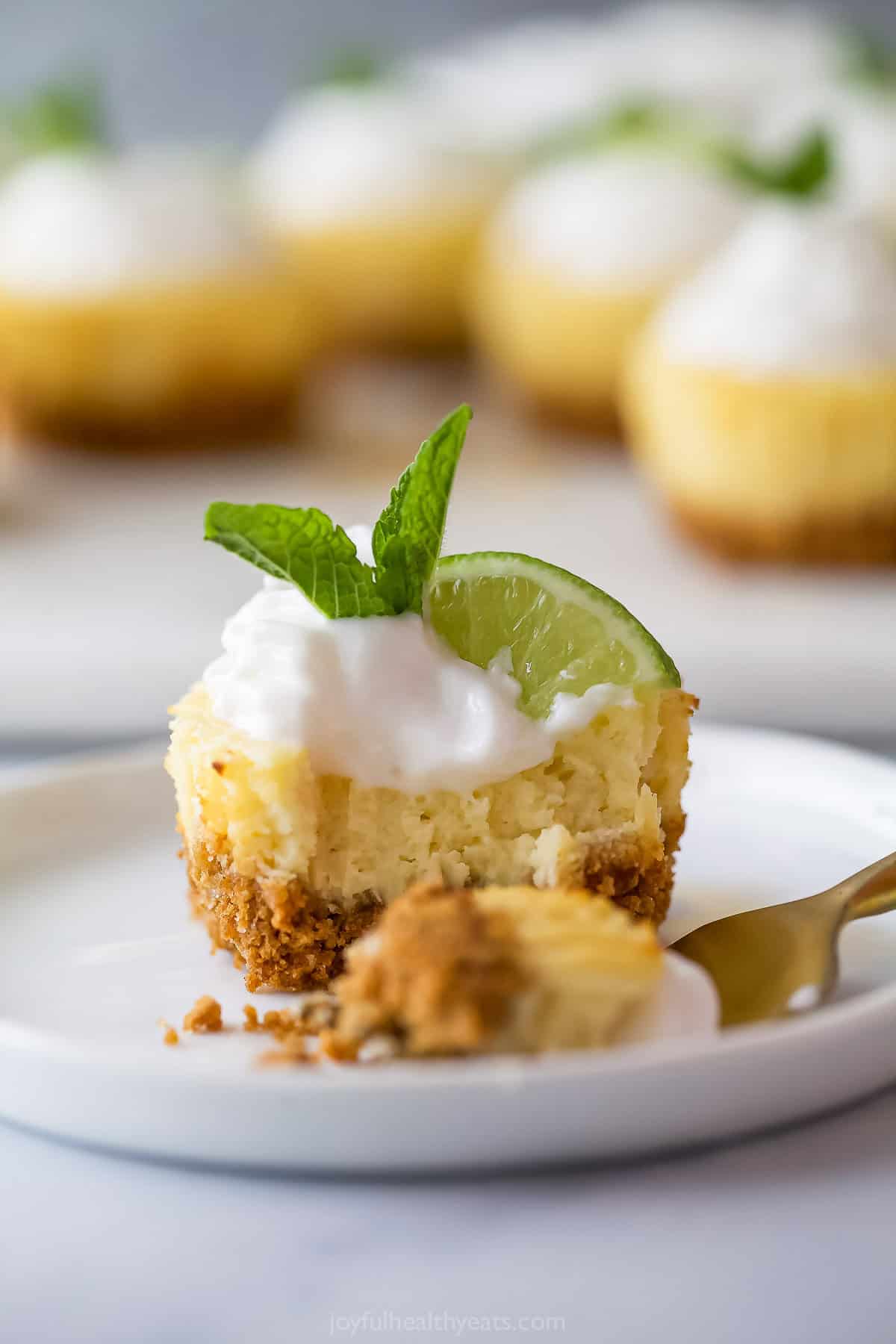 Tart and sweet, creamy and fluffy, these mini key lime pies are a delightful one-bite dessert to whip up for parties—and just because. Mini key lime pie on plate with fork