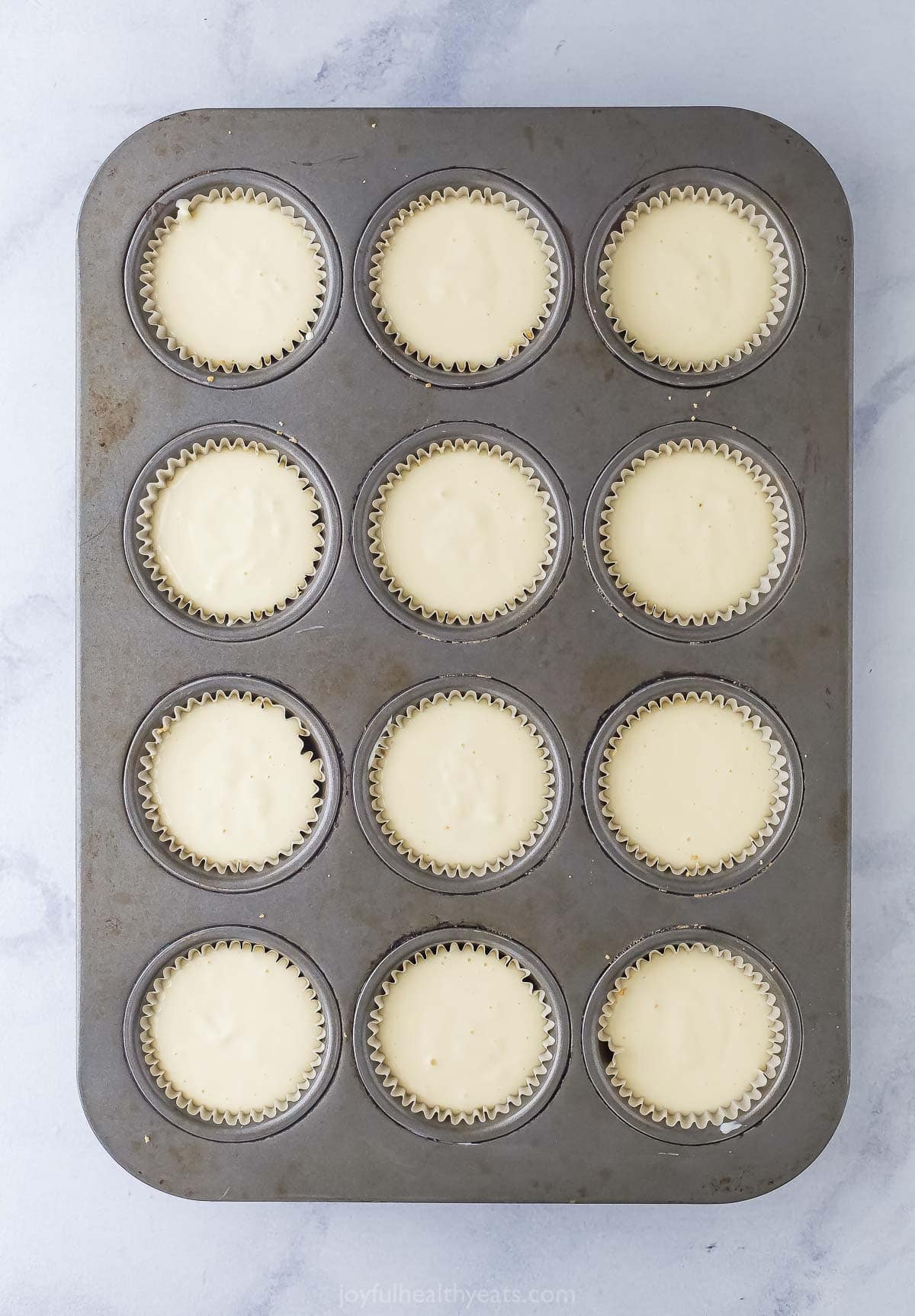 Tart and sweet, creamy and fluffy, these mini key lime pies are a delightful one-bite dessert to whip up for parties—and just because. Overhead view of unbaked mini key lime pies