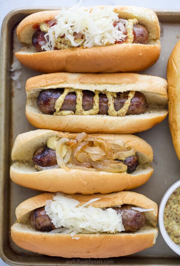 4 hot dogs with different toppings.
