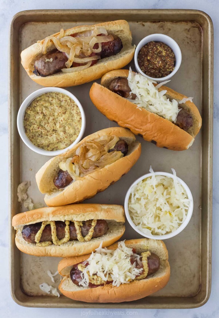 Tray of hot dogs with different toppings.