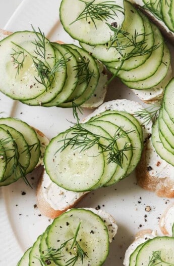 Cucumber sandwiches with fresh dill on top.