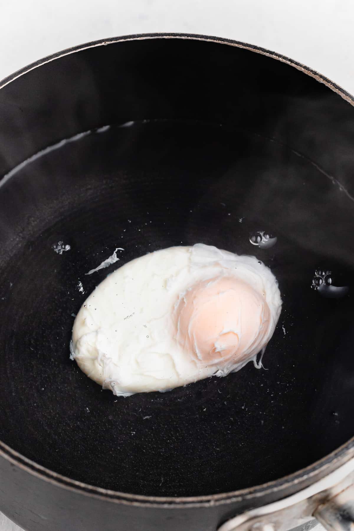 An egg cooking in water