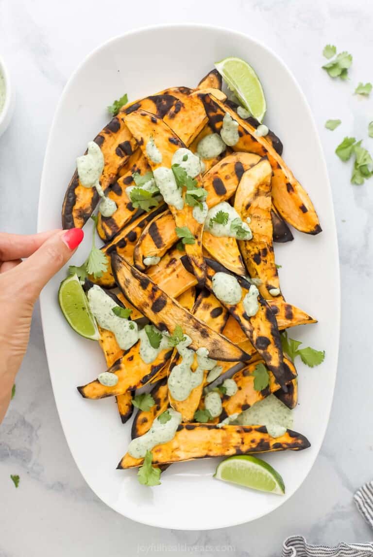 Sweet potatoes with cilantro lime crema on top.