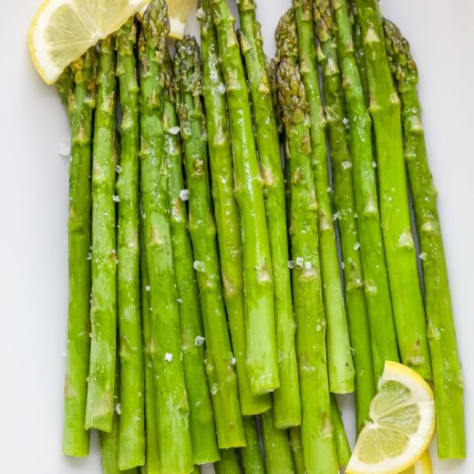 Roasted asparagus on platter with lemon slices