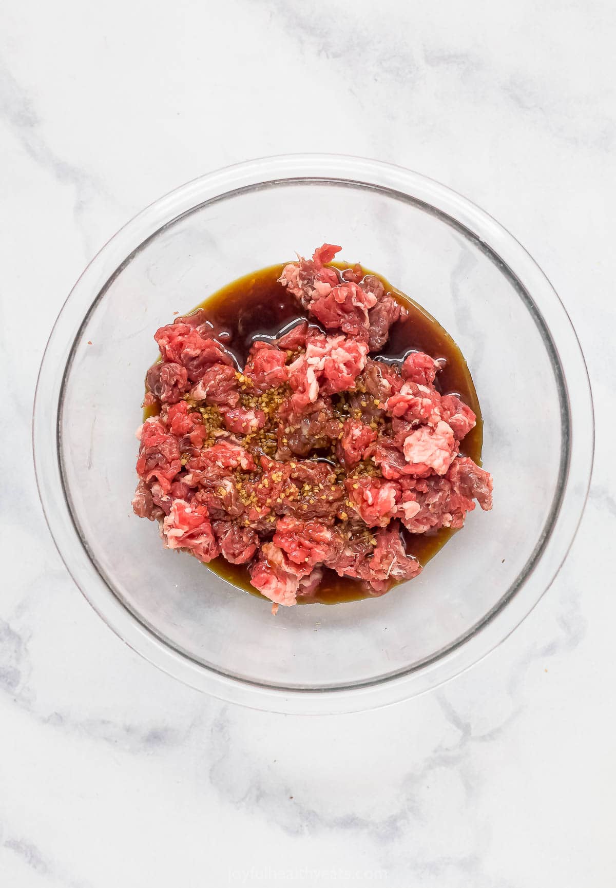 Marinating the steak in a bowl. 