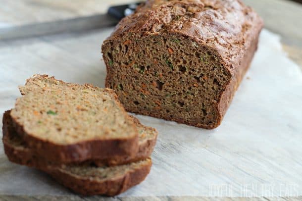 A loaf of Carrot Zucchini Bread with a couple slices stacked up