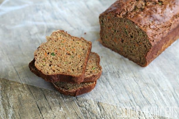 A loaf of Carrot Zucchini Bread with a couple slices stacked up