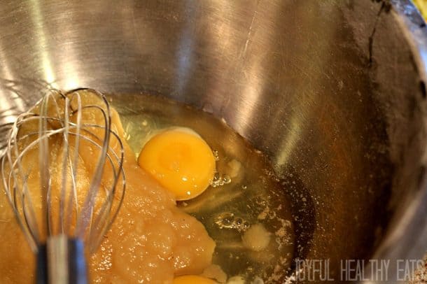 Wet ingredients for Carrot Zucchini Bread in a mixing bowl with a whisk