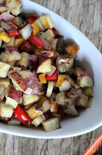 A tray full of Easy Homemade Breakfast Potatoes with bright red peppers and onions/ #breakfastrecipes #roastedpotatoes