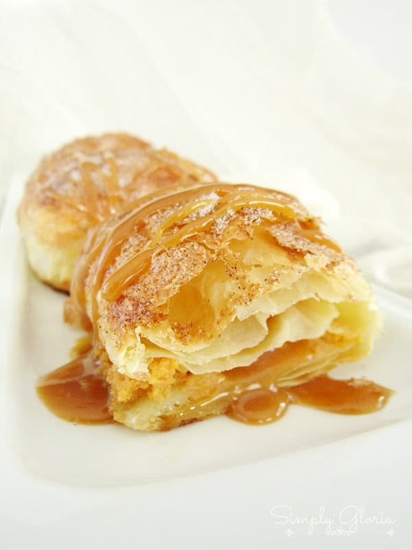 A flaky pumpkin empanada made with puff pastry and drizzled with caramel sauce