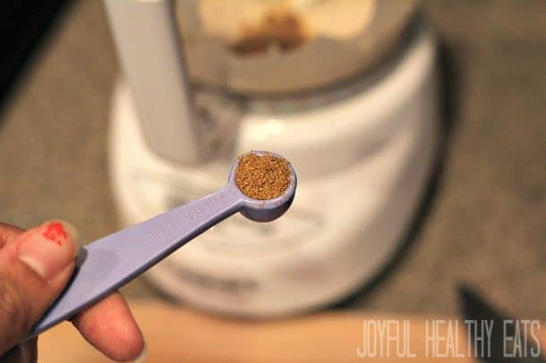 A teaspoon measure filled with cumin