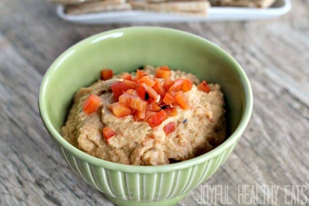 Green bowl of red pepper hummus