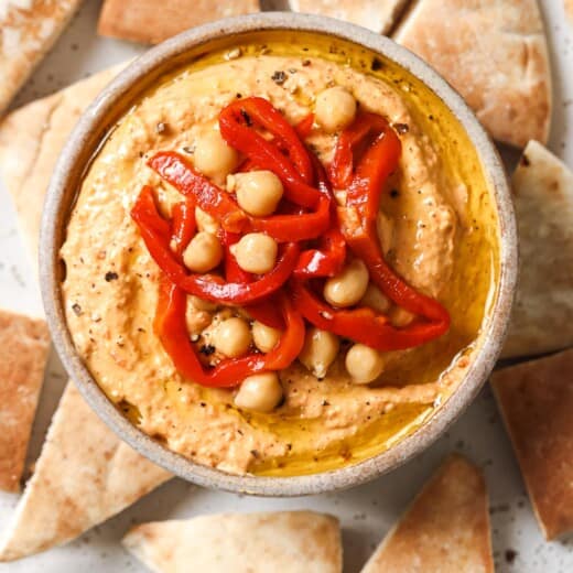 Over-head photo of creamy roasted red pepper hummus.