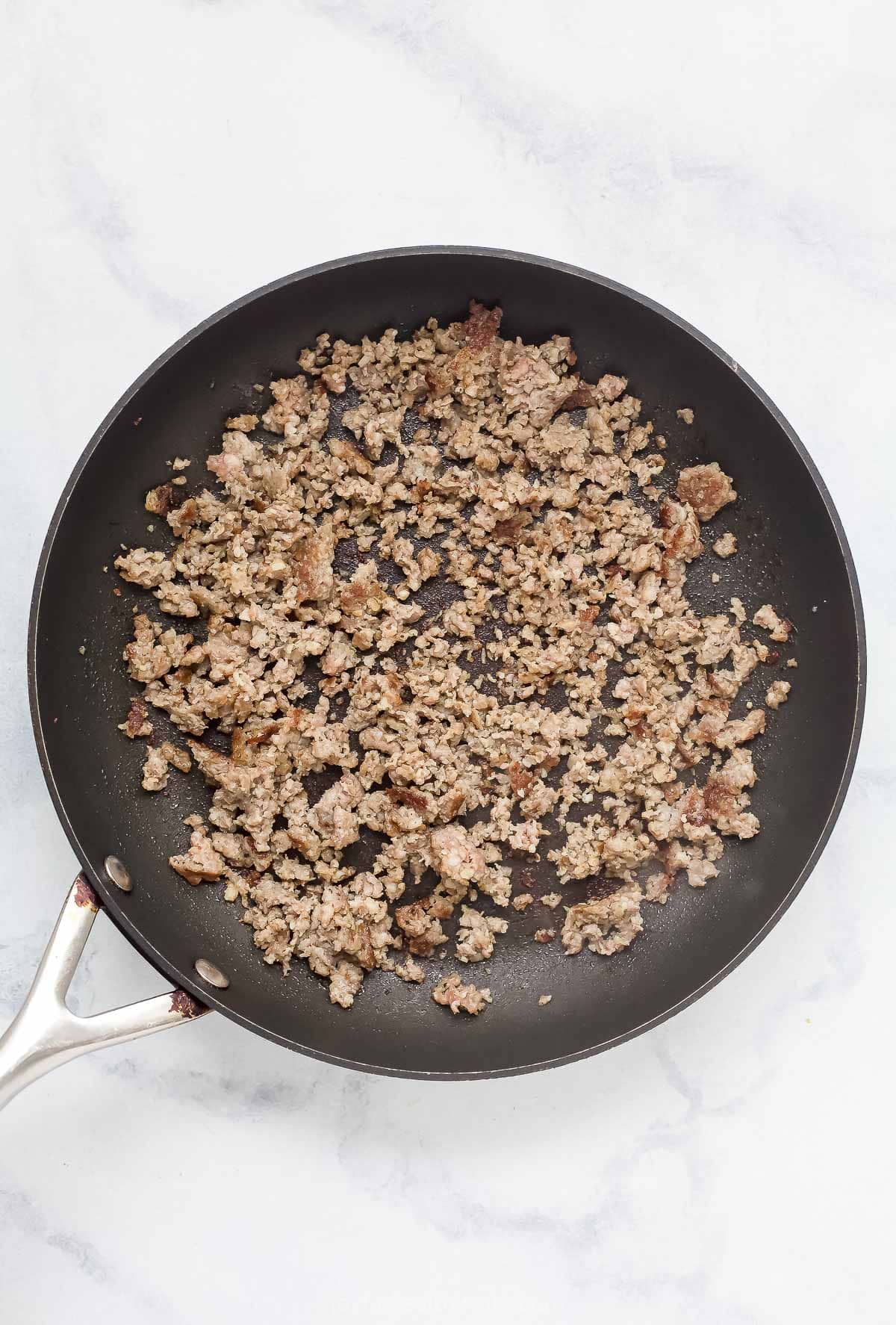 Browned sausage in the skillet. 