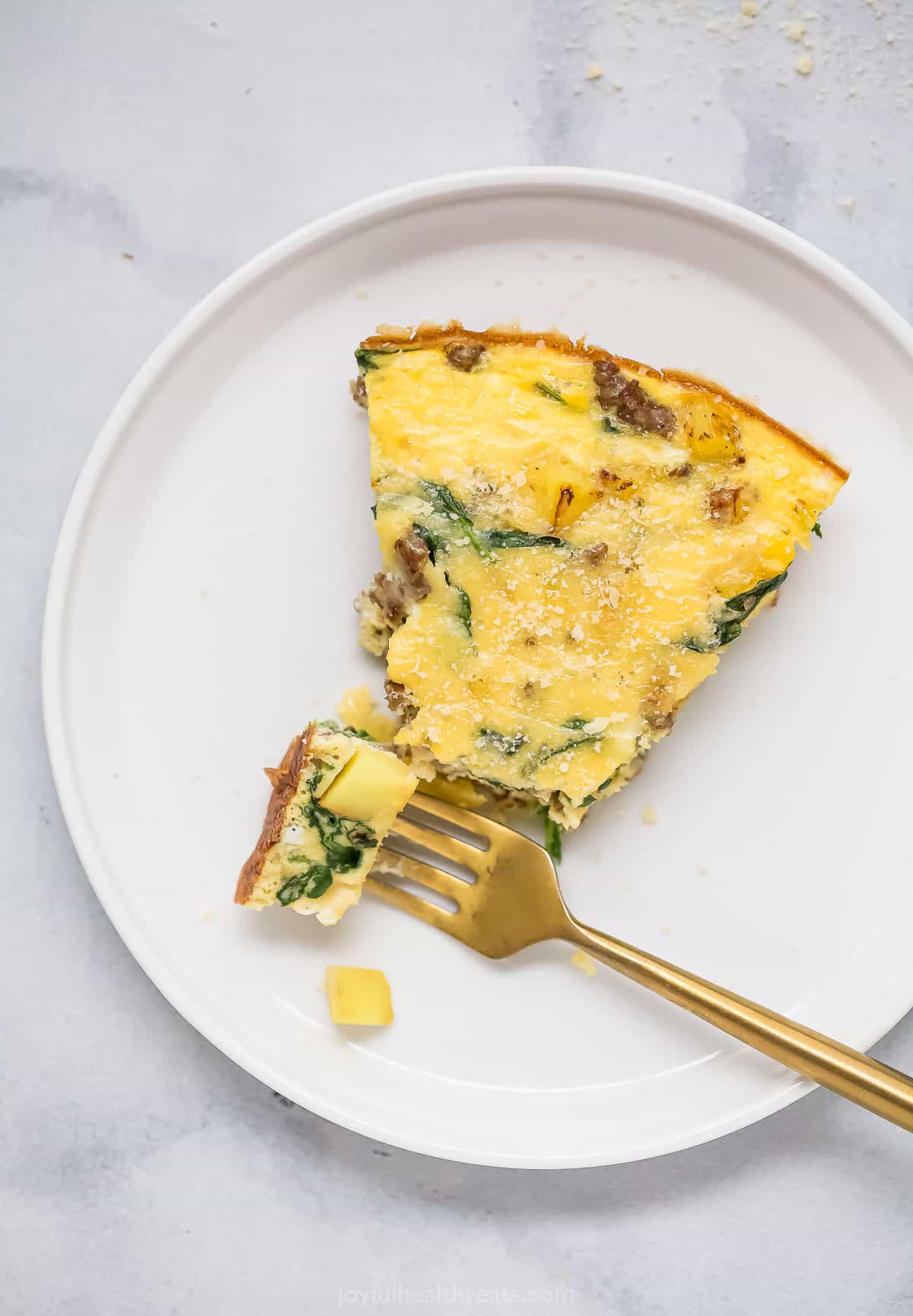 Digging into a slice of potato frittata with a fork. 