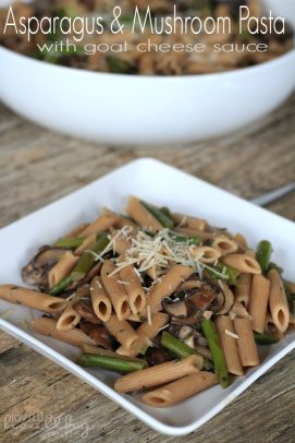 Asparagus & Mushroom Pasta on a plate with shredded cheese on top.