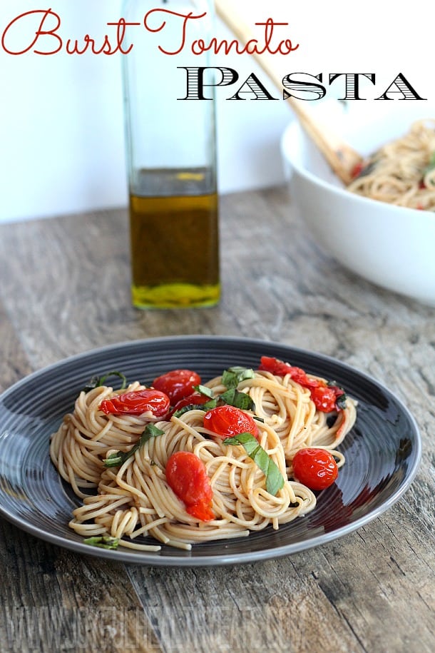 A bowl of spaghetti with burst grape tomatoes and fresh basil with recipe title text for Burst Tomato Pasta