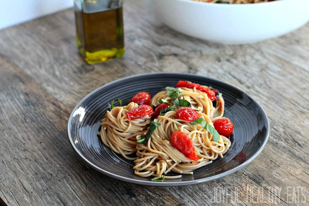 Burst Tomato Pasta with fresh basil in a pasta bowl