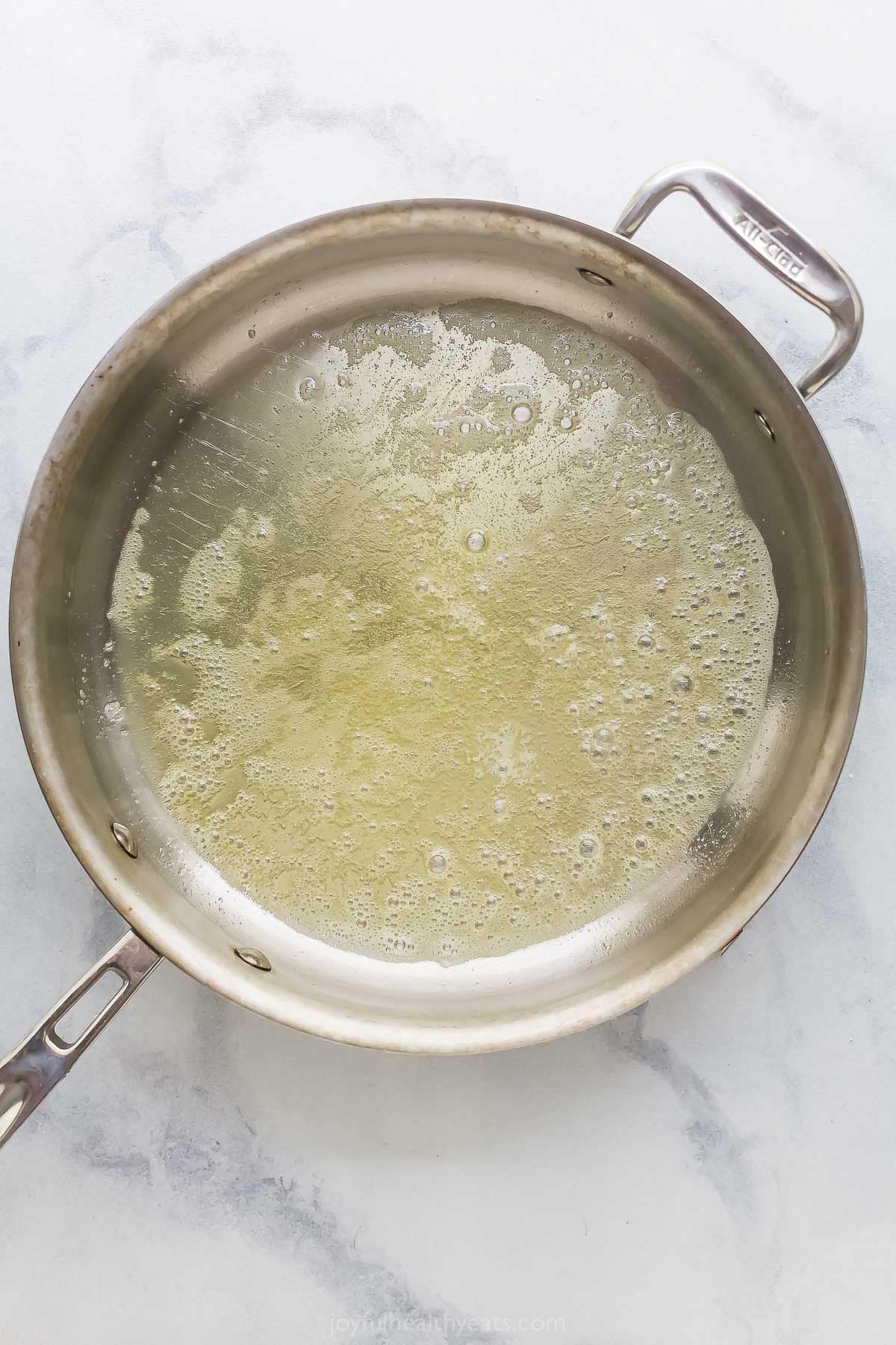 This Lemon Garlic Pasta is a 15-minute dinner elevated enough for a date night, but it's made with a short and simple list of ingredients! Oil and butter in skillet