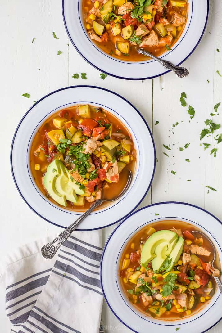 overhead photo of three bowls filled with hearty chicken tortilla soup