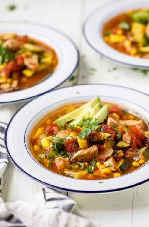 3 bowls of chicken tortilla soup with avocado.