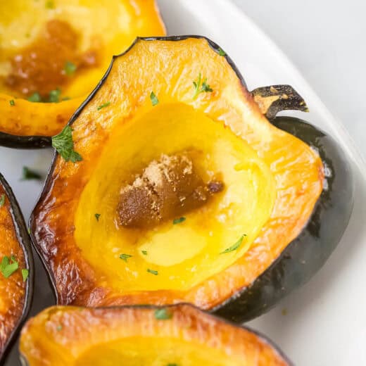 Close-up of a tender acorn squash with brown sugar and melted butter.