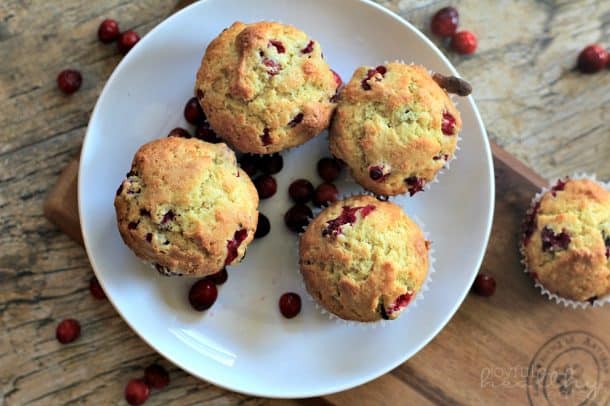 Top view of four Cranberry Orange Muffins on a white plate