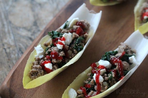 Two Endive leaves filled with ground lamb mixture and Cherry Balsamic Sauce