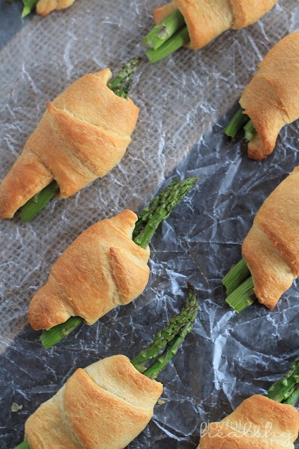 Asparagus Rollups Lined up on a Piece of Wax Paper