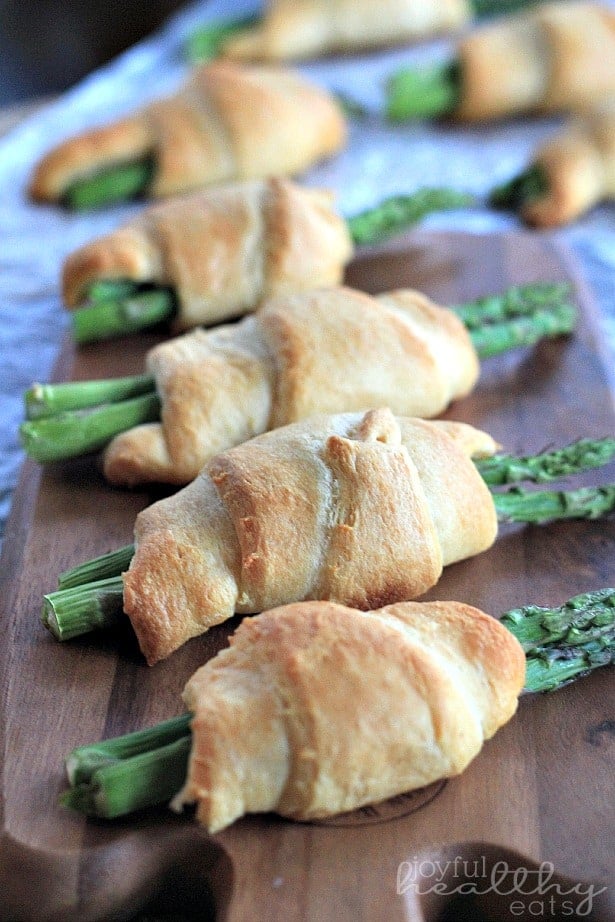 Asparagus Rollups Arranged in a Line on a Wooden Board