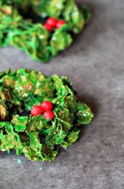 Four Christmas Wreath Cookies on a Piece of Parchment Paper