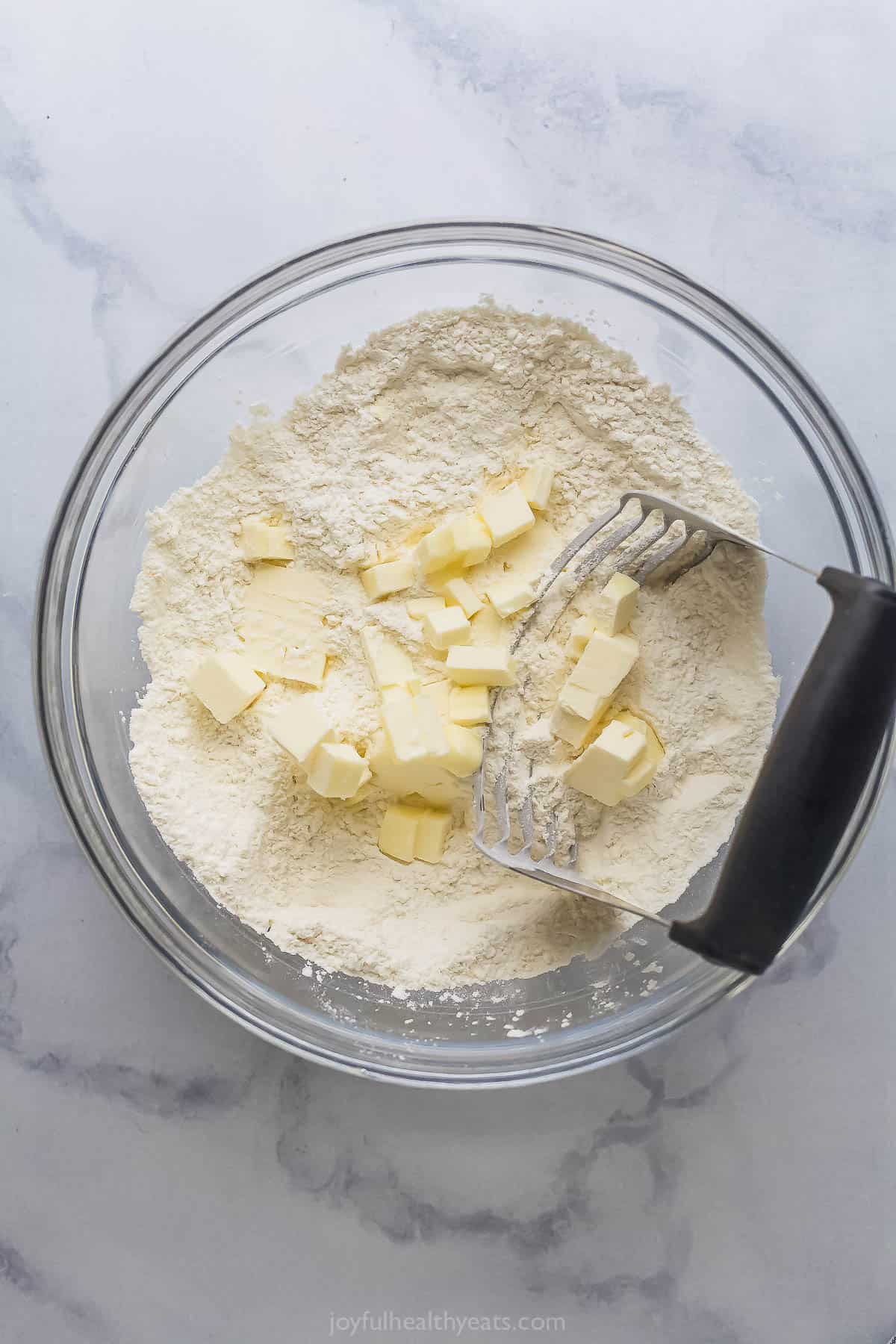 Incorporating the butter into the dry ingredients. 