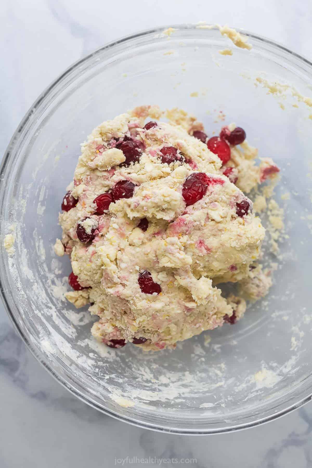 Adding the cranberries to the dough. 