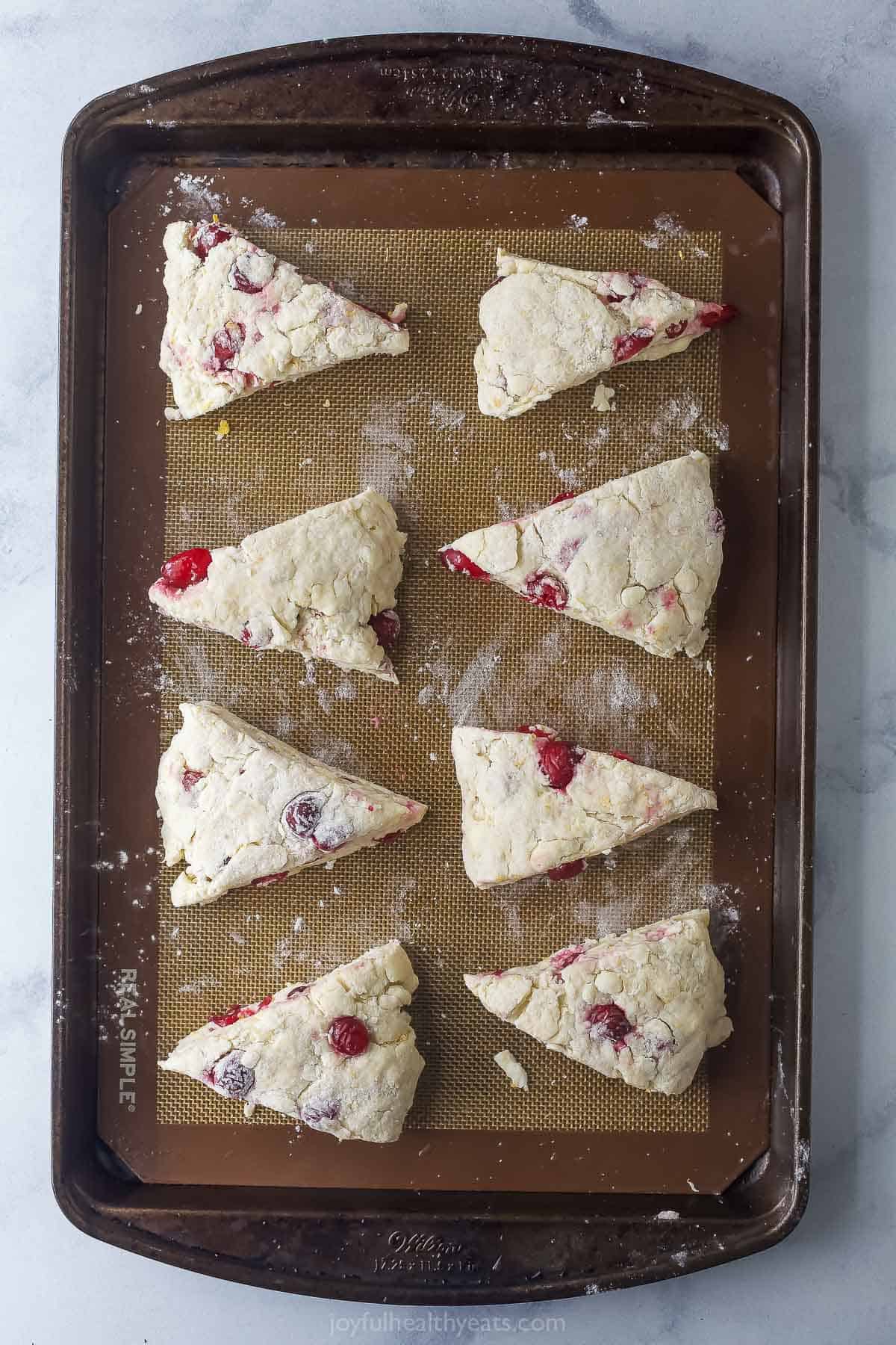 Sliced scones on the baking sheet. 