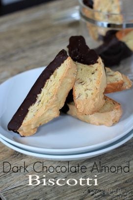 Title Image for Dark Chocolate Almond Biscotti and a white plate with chocolate dipped biscotti