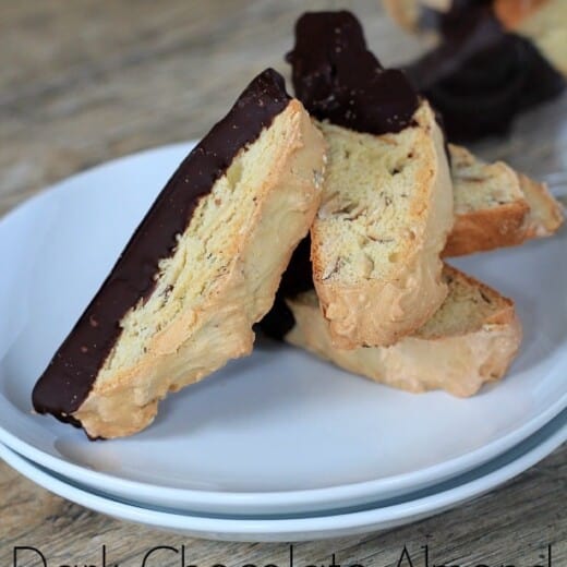 Title Image for Dark Chocolate Almond Biscotti and a white plate with chocolate dipped biscotti