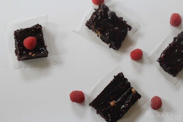 Top view of Dark Chocolate Raspberry Swirl Brownie squares with fresh raspberries