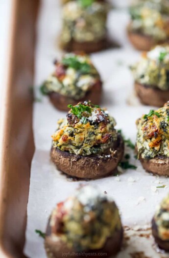 spinach stuffed mushrooms on a baking sheet