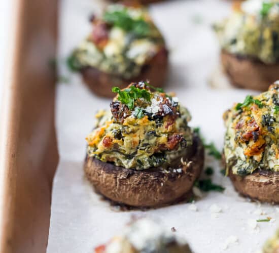 spinach stuffed mushrooms on a baking sheet