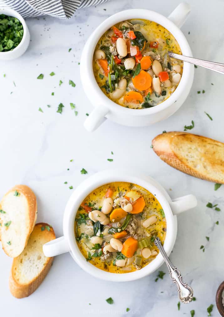 overhead photo of bowls filled with creamy tuscan white bean soup