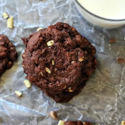 A Stack of Mint Dark Chocolate Chip Cookies Beside a Glass of Milk