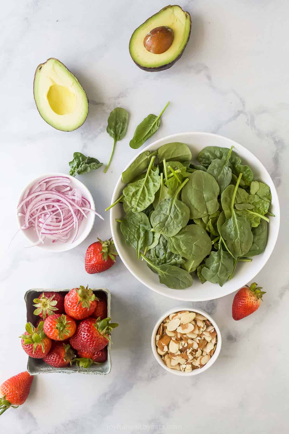 Ingredients for a strawberry avocado summer salad. 