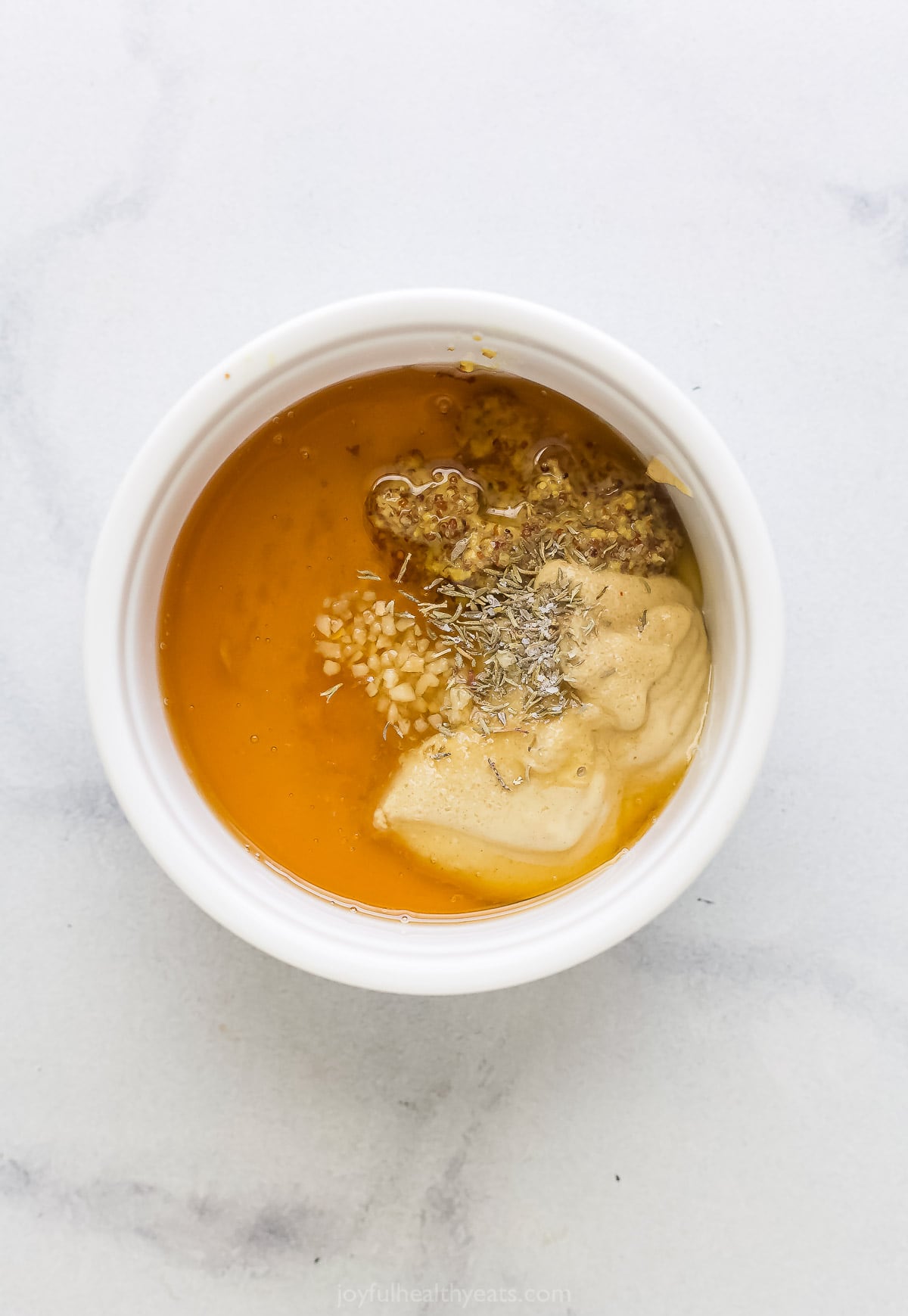 Adding the dressing ingredients to a bowl.