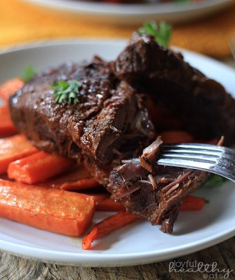 Crock Pot Balsamic Braised Beef Short Ribs with roasted carrots on a plate