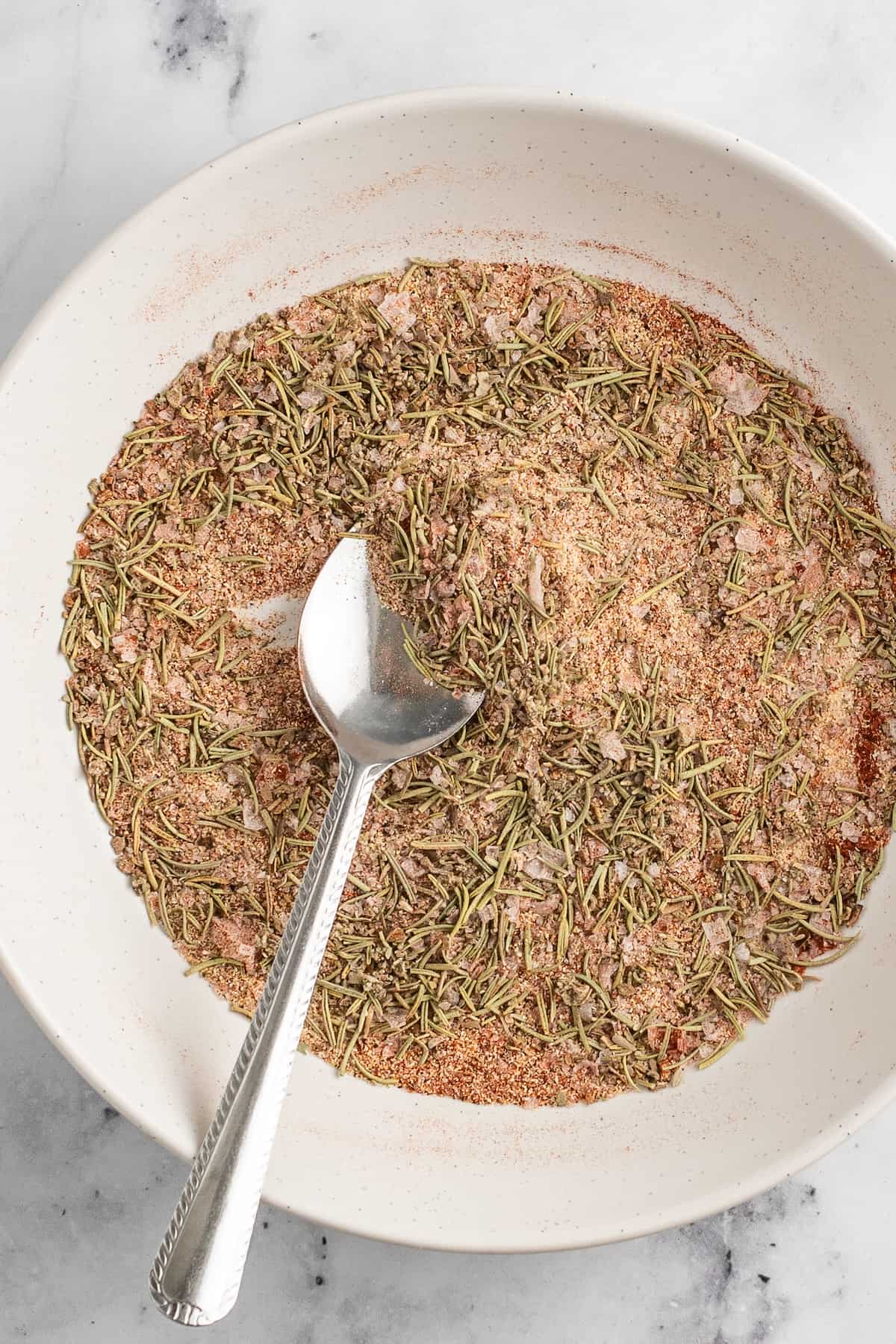 making a dry spice mixture in a small bowl