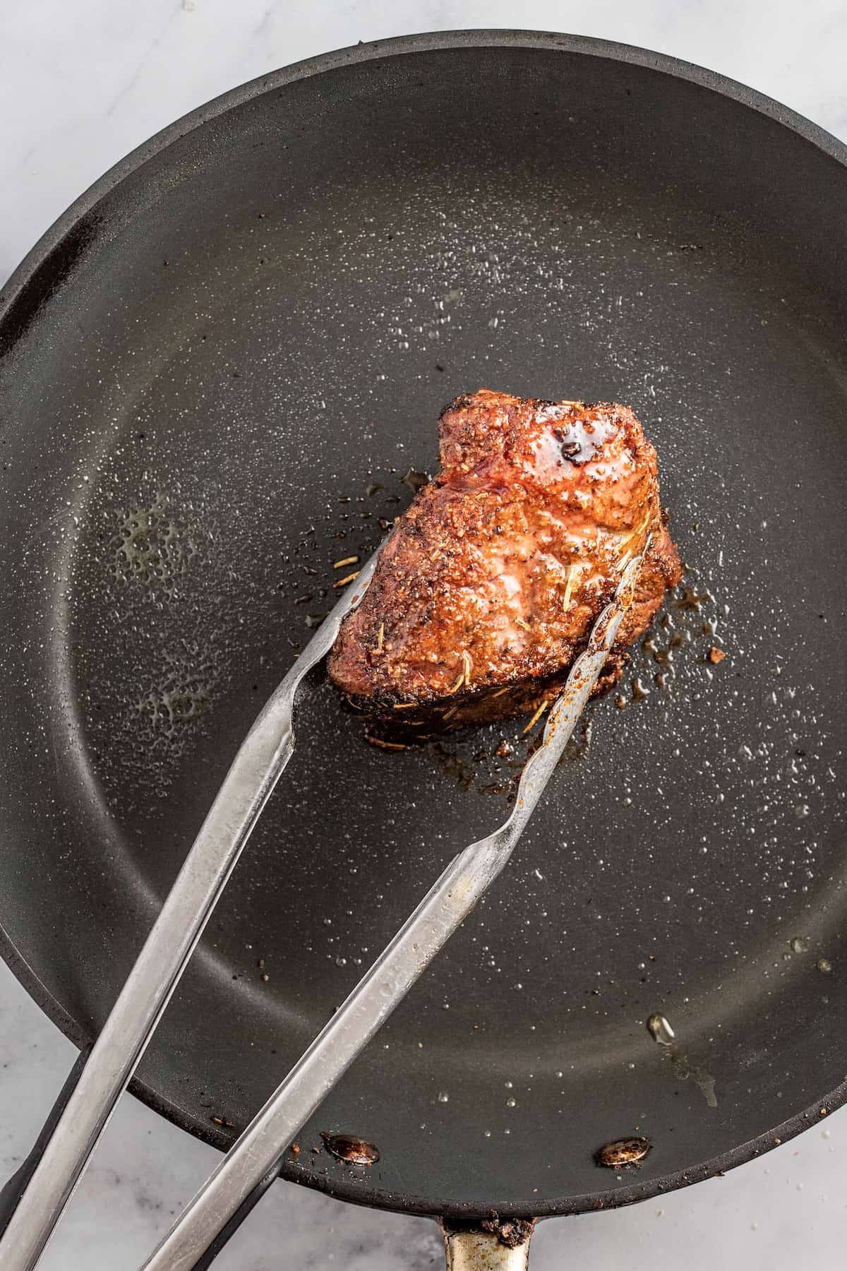 Slow Cooker Balsamic Braised Beef Short Ribs are a hearty Paleo recipe. Made with juicy beef short ribs & balsamic vinegar, simple yet fancy! searing one short rib in a saute pan with tongs